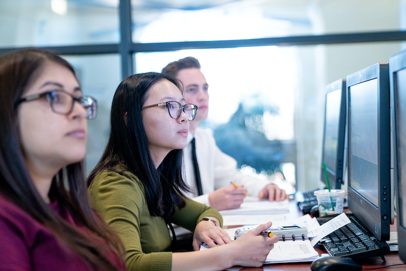 Three students in School of Business computer lab