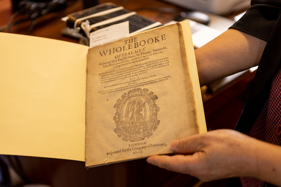 someone holding up an old book