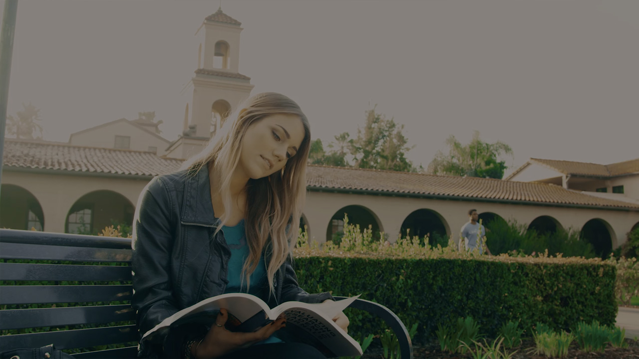 Student reading in the front of CBU