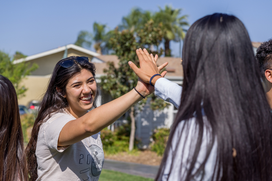 cbu students high fiving