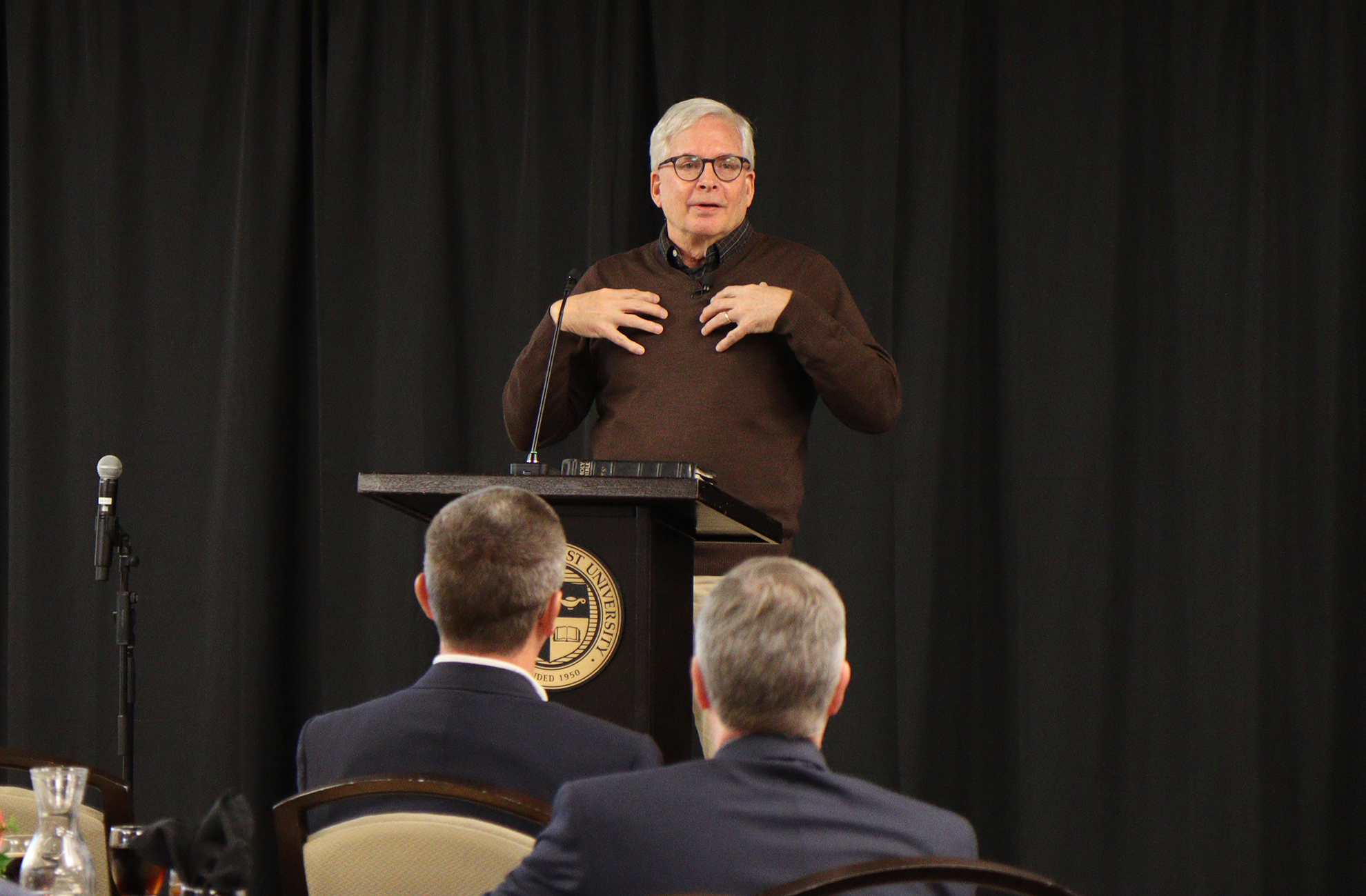 Dr. Gregg Allison speaking in front of a crowd at CBU