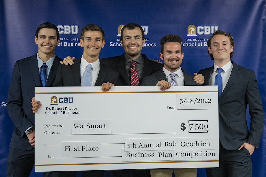 five students holding their winning check