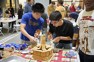 Students making gingerbread house