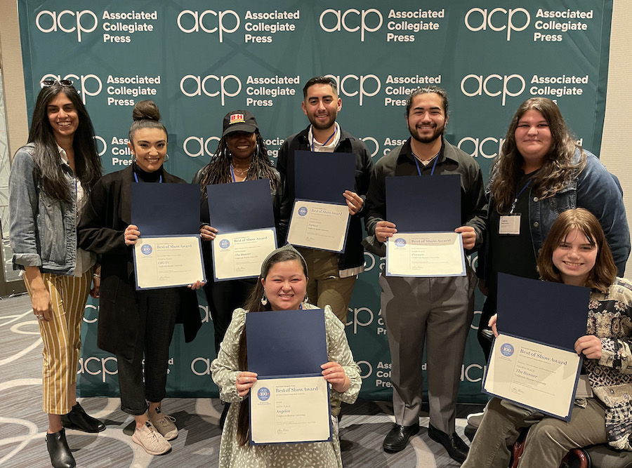 students posing with their awards