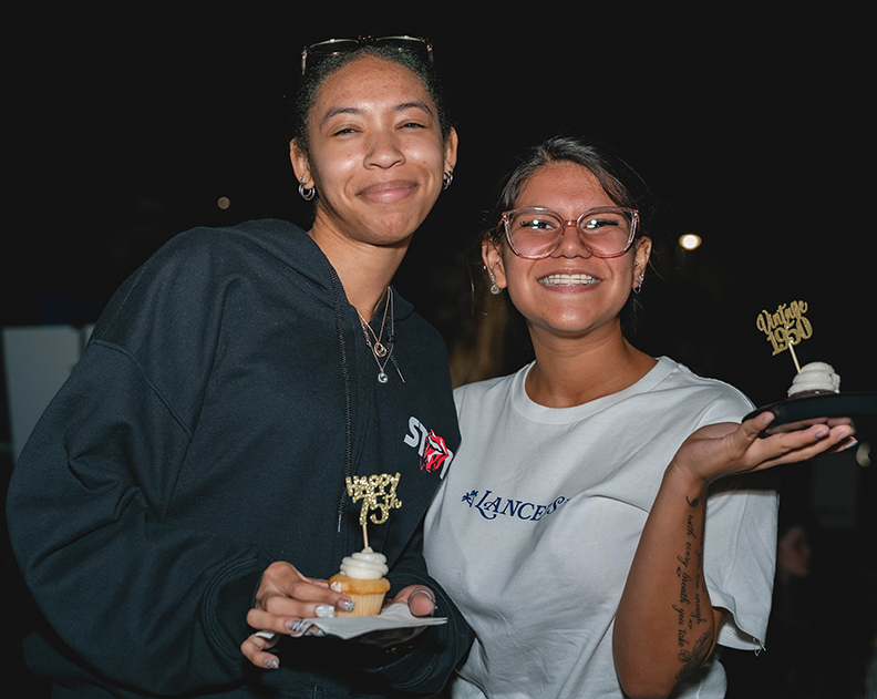 students holding cupcakes
