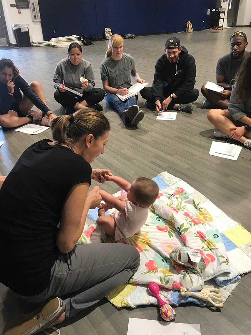 As infants rolled over and responded to their cheeks being stroked, students from California Baptist University watched closely, observing each of their movements.