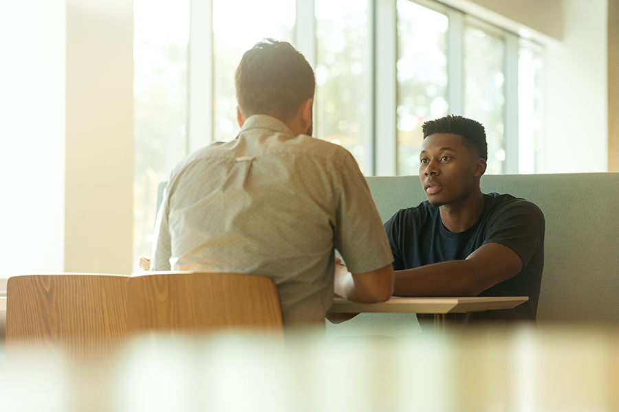 Two people sit at a table 