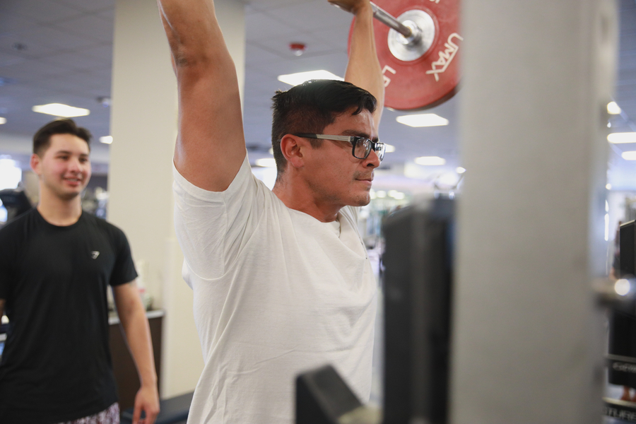 student training another student in gym