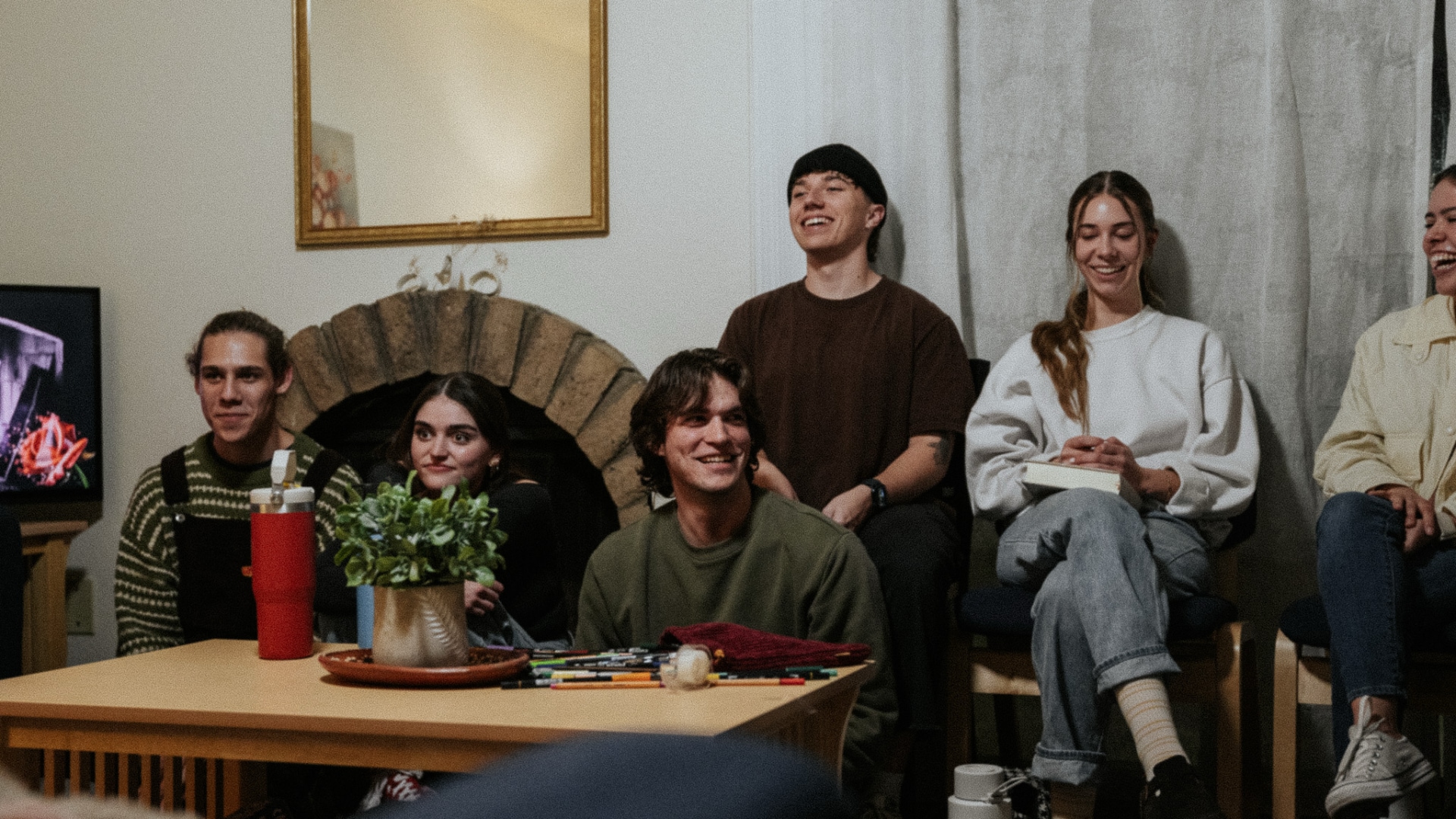 People sitting around a room with bibles