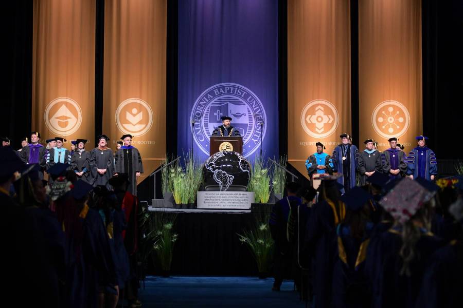 CBU faculty and leadership on stage at commencement