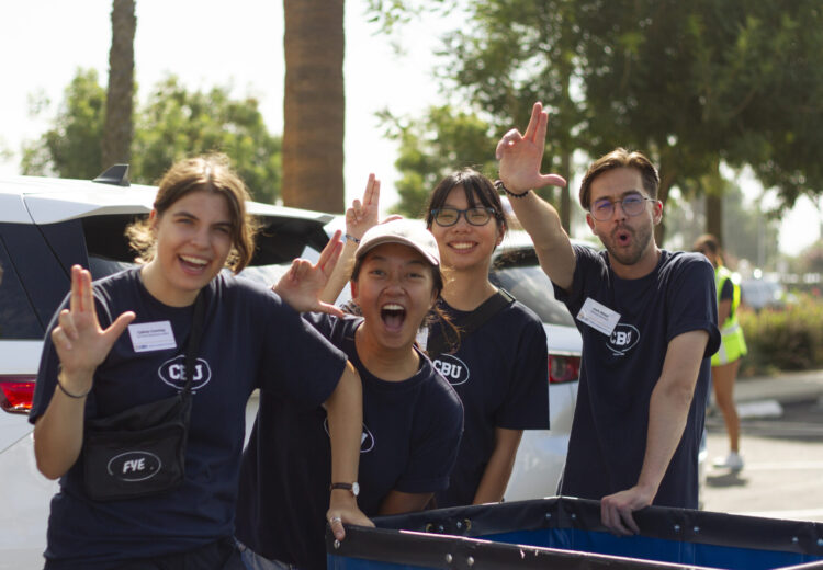 Students posing with a Lance up hand sign