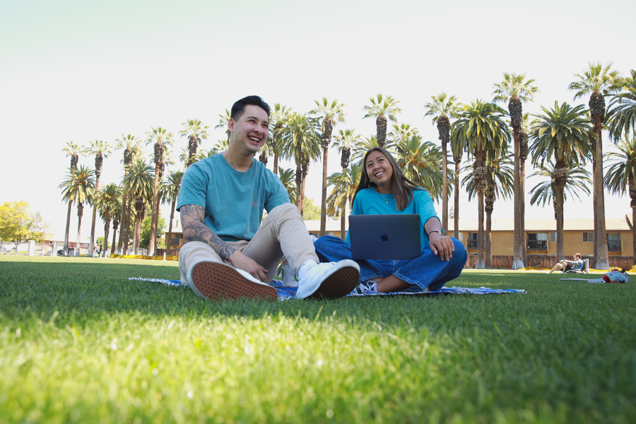 students sitting on the grass