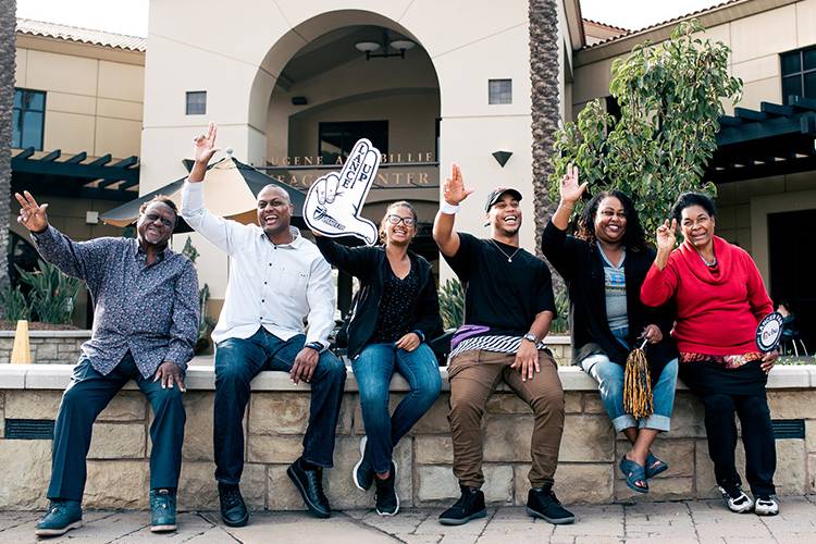Family lancing up at the front of the Yeager Center