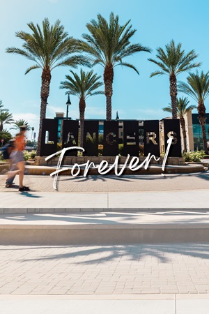 Student outside building with the logo CBU Gives at the top